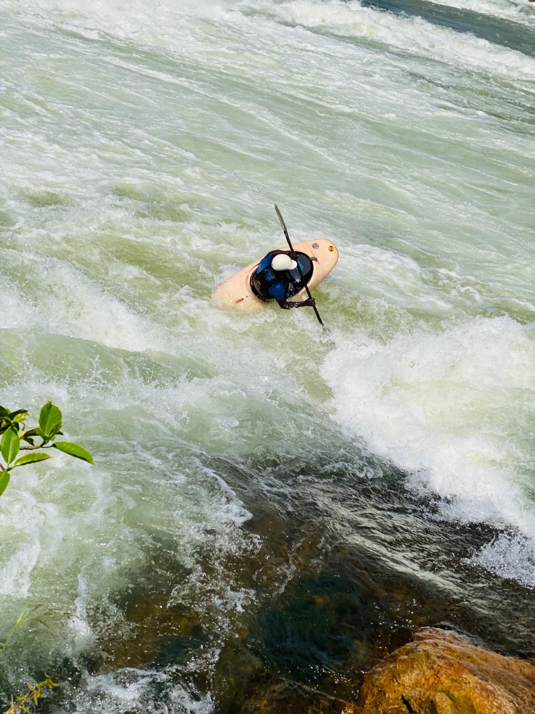 Kayaker riding the Nile rapids at Jinja — our own photo